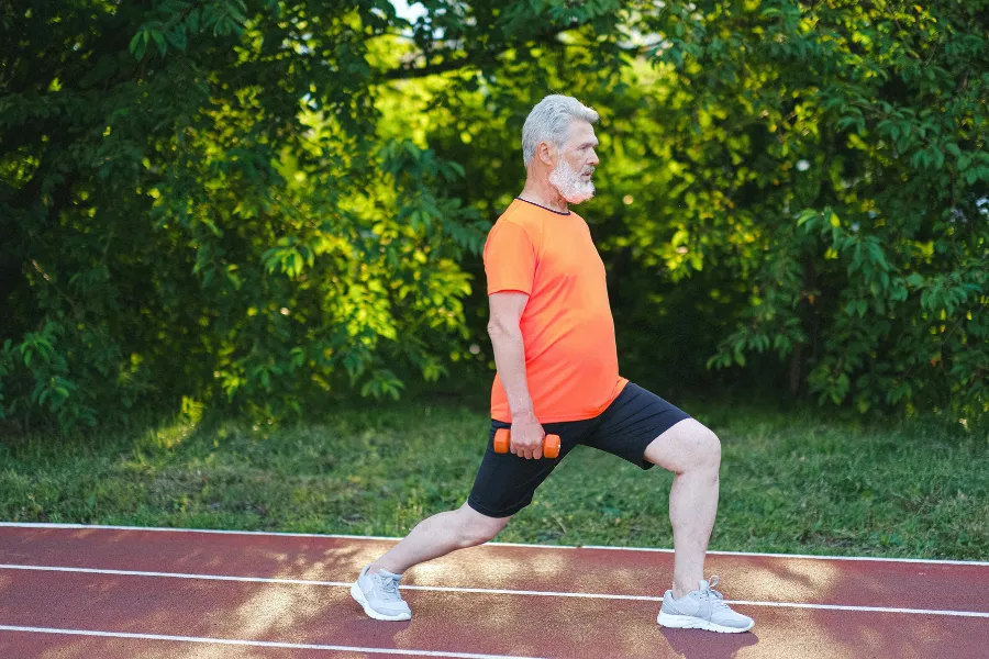 Woman doing lunge on a track