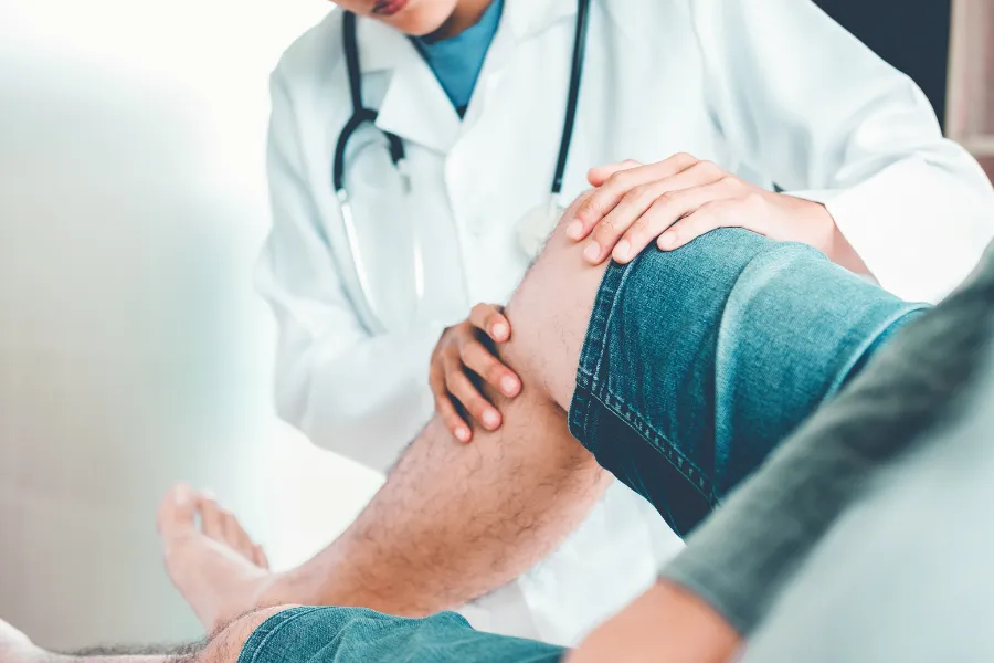 Doctor helping with knee