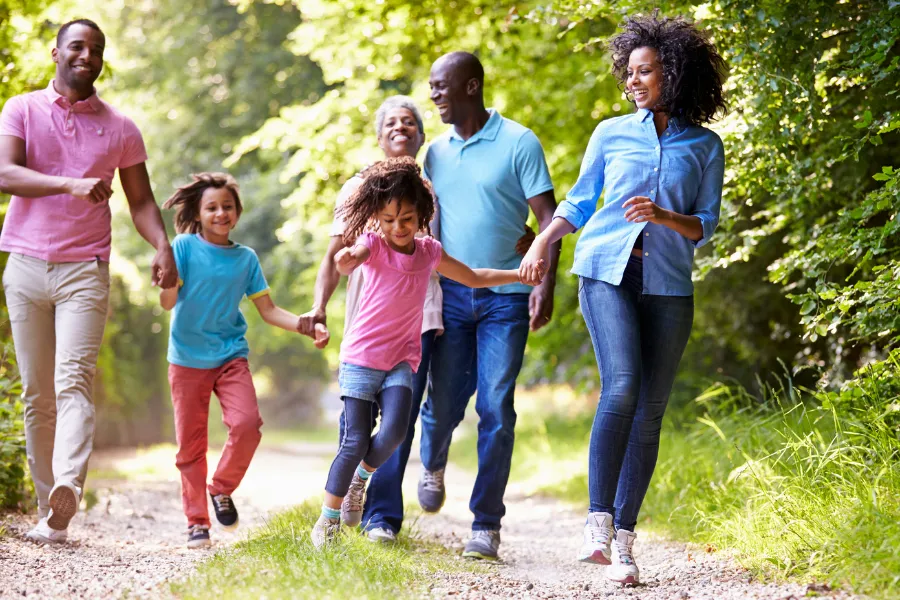 Happy family running on an outdoor path