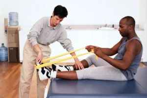 Physical therapist helping patient improve mobility during the LDRT healing process